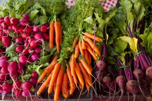 Fresh vegetables on display in a farmers market.